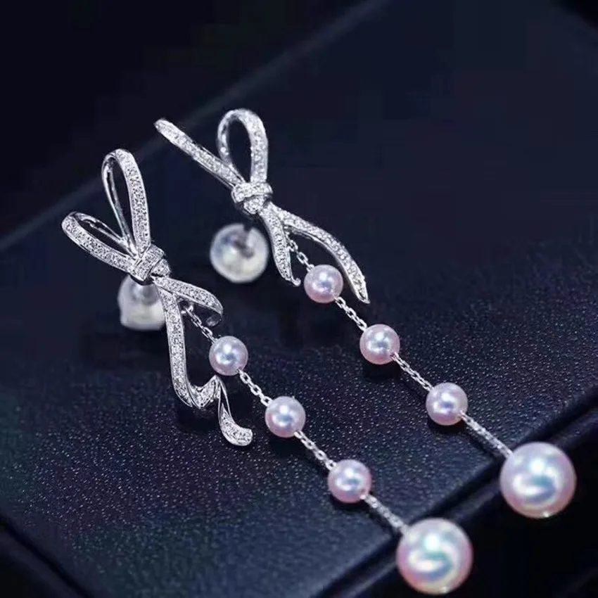 

Luxury Bow Pearl Drop Earrings for Women – Sparkling Crystal Ribbon Design with Dangling Gradient Faux Pearls