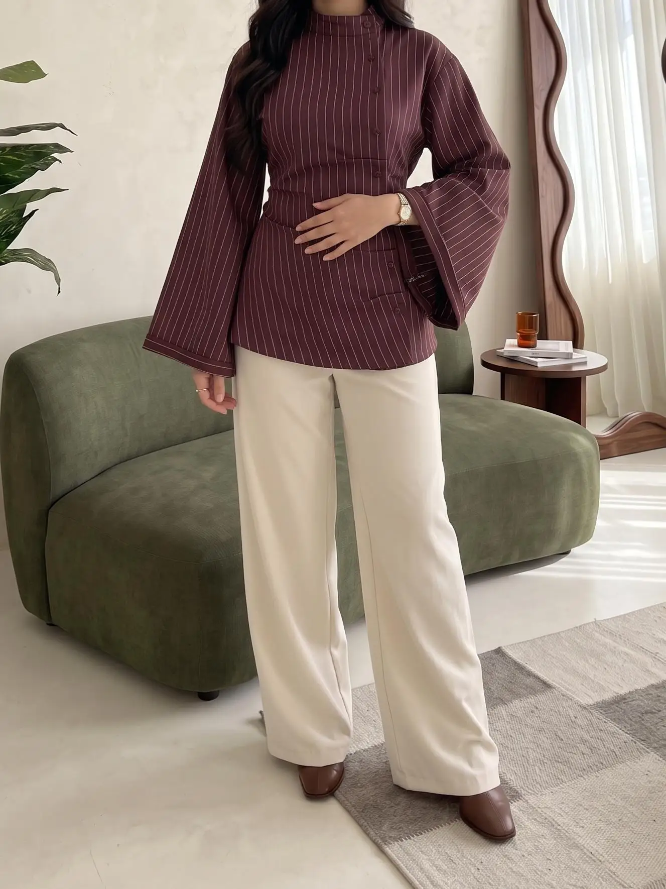 Elegant women’s vertical-striped shirt, featuring a stand collar with an asymmetrical button placket and long, flared sleeves.