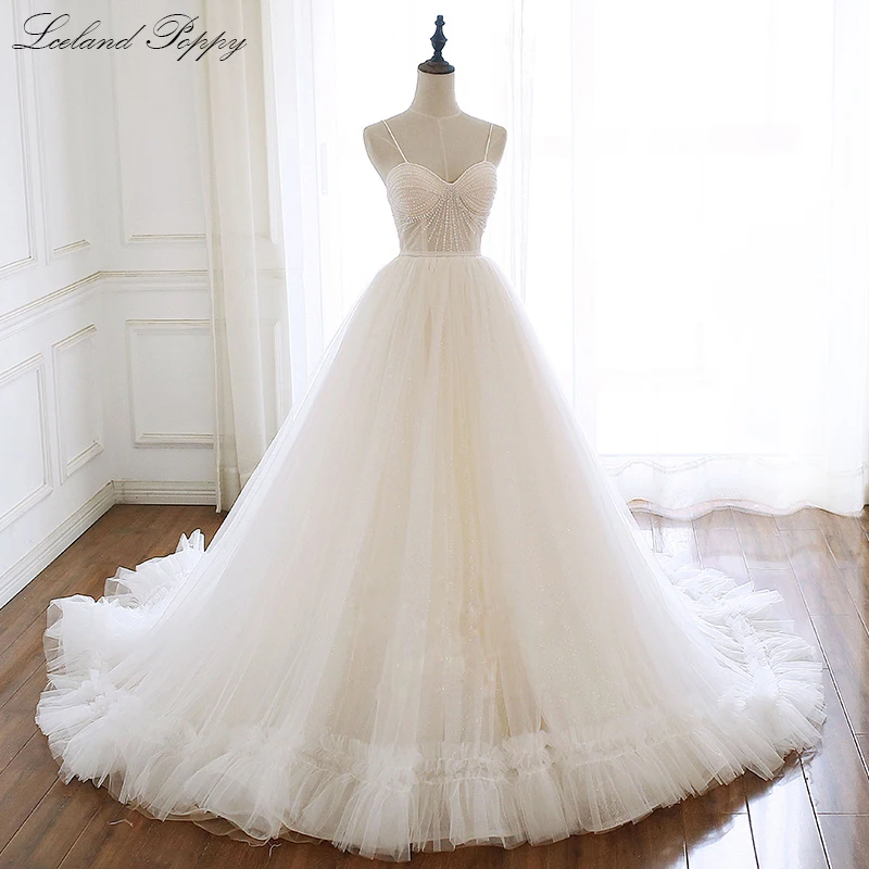 

Lceland Poppy A-line Shiny Wedding Dresses Sleeveless Spaghetti Straps Beaded Tulle Floor Length Bridal Gowns