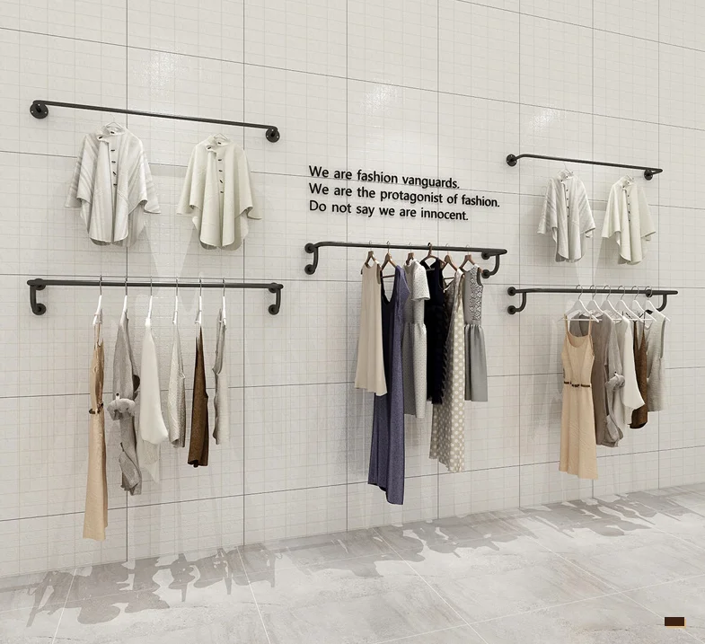 

Hanging on the front side of the upper wall of the clothing store shelf is a wall-mounted point hanging hanger for men and women