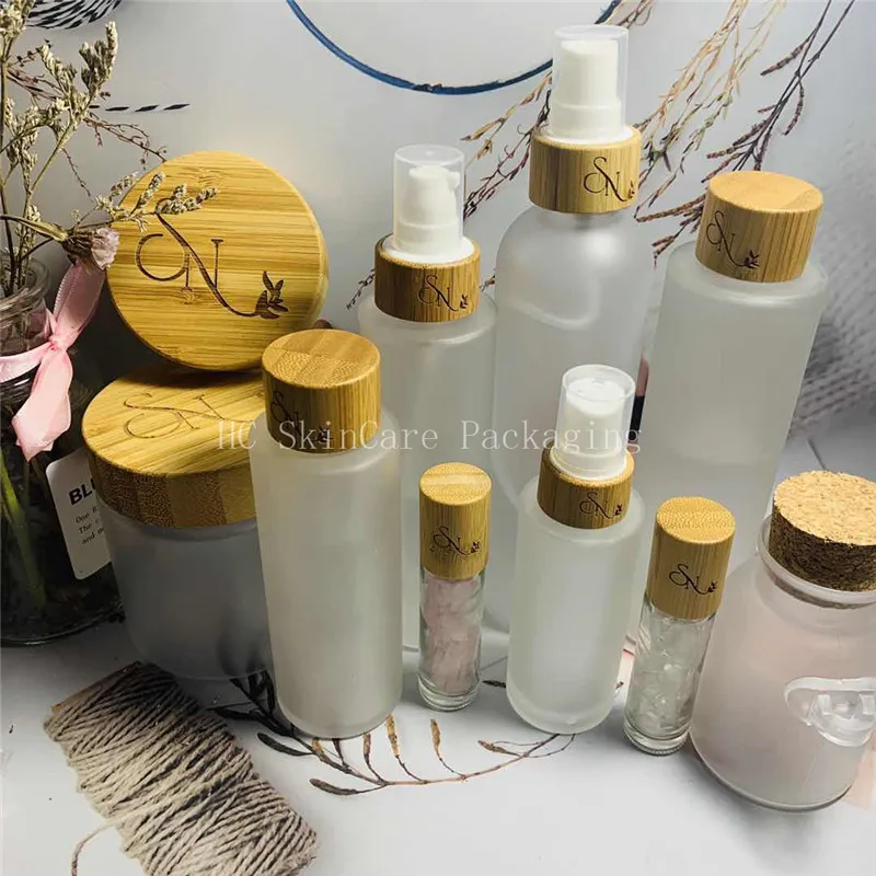 

Custom Logo Toner Water Bottle and Face Cream Empty Frosted Glass Jar Screw Bamboo Cap Bottle Packaging Skin Care Container