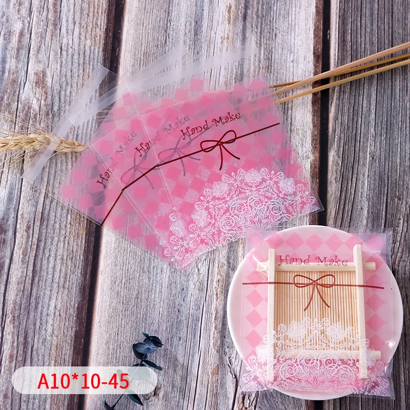 100 個ピンクスクエアステッチ彫刻クッキー包装スノーフレーククリスピー石鹸ビスケットセロハンベビーシャワーパーティーギフトパック