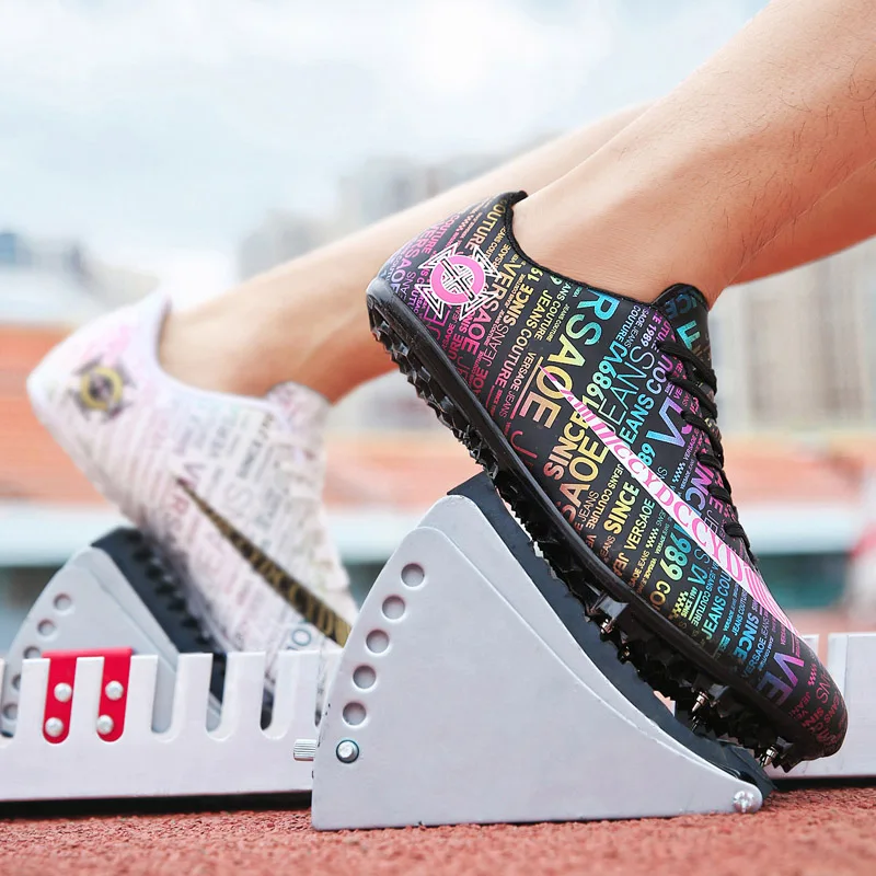 

Men Kids Track Field Training Spikes Shoes Women Athlete Running Nail Newspaper Graffiti Shoes Mens Spike Racing Sneakers