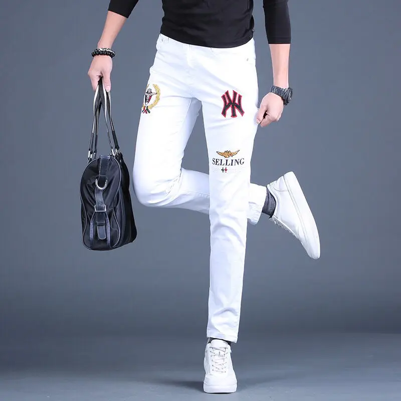 Mens embroidery slimming white jeans stretch denim pants Korea version trendy black jeans pants for men.