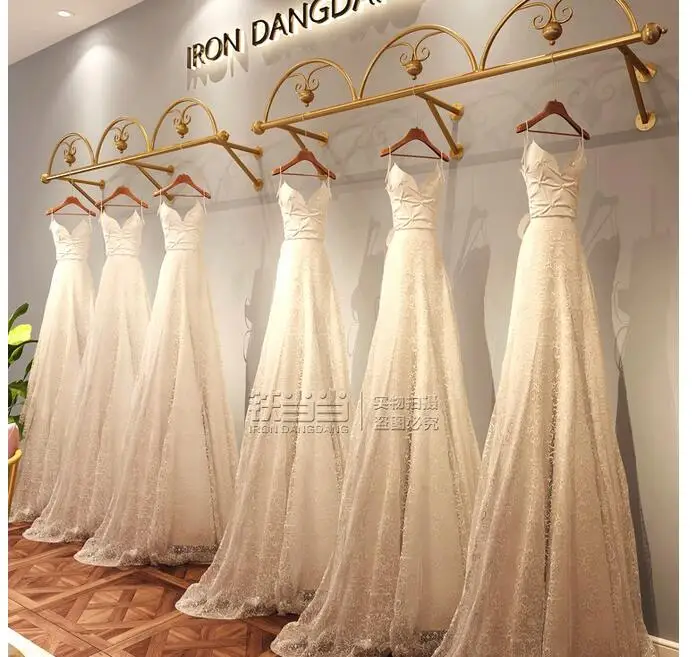 

Clothing store hanger golden wedding dress store display rack wall hanging dress wall display rack wedding dress display rack