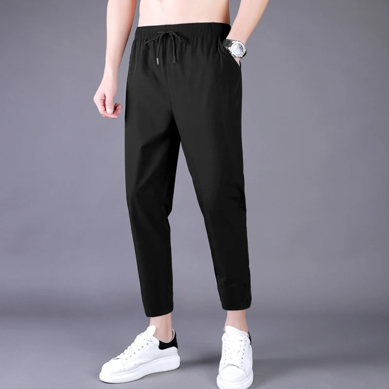 Pantalones finos de verano para hombres, pantalones de chándal elásticos de seda de hielo sueltos de tubo recto de nueve, tendencia coreana, primavera y otoño, estudiantes