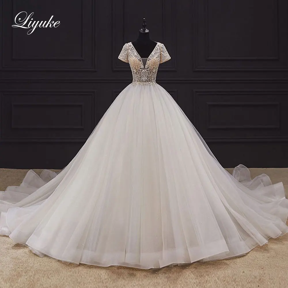 

Liyuke Gorgeous Deep V-Neckline Ball Gown Wedding Dress Sparkle Rhinestones Skin Nude Tulle vestido de noiva Of Short Sleeve