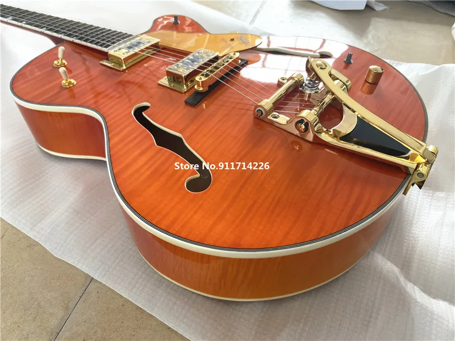 High quality custom version of jazz double F hole orange electric guitar gold large rocker vibrato