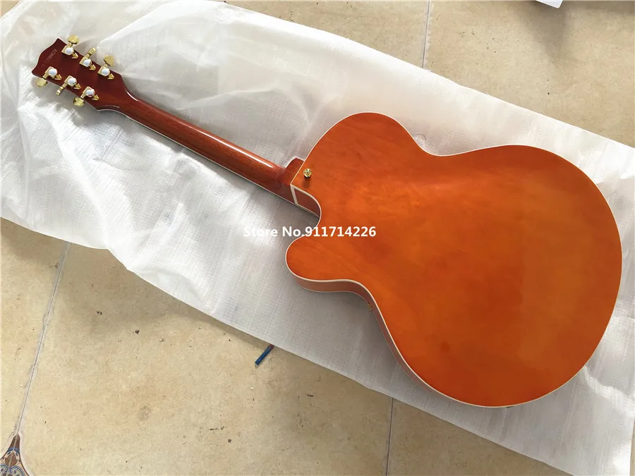 High quality custom version of jazz double F hole orange electric guitar gold large rocker vibrato