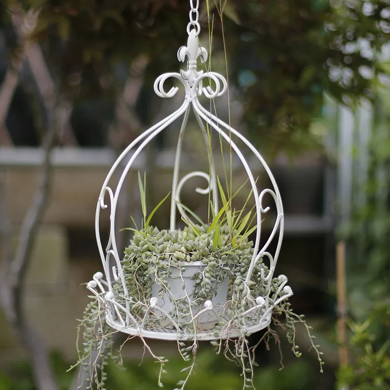 Idyllic wrought iron hanging basket flower pot hanging swing potted flowers and green plants balcony garden decoration