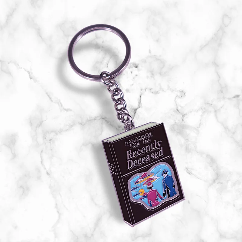 Tim Burton Betelgeuse Handbook Adam and Barbara movie spooky Gothic jewelry keychain key ring reads like stereo instructions