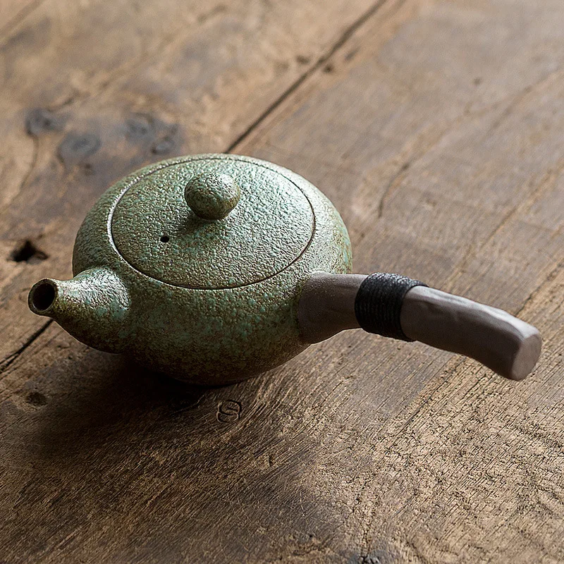 Ceramic teapot wooden handle side handle pot household Kung Fu Oolong filter teapot creative pottery tea set to make tea