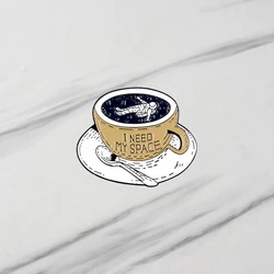 A Set Of Cups For Drinking Coffee, A Sentence Written, An Astronaut's Brooch Lying In Gift For Friends