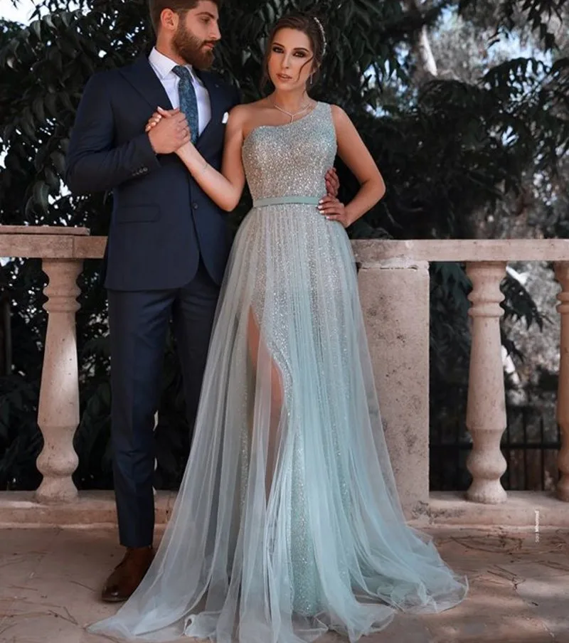 

Sparkly Arabic Prom Dresses Long 2025 Sequin Tulle Light Blue Evening Gown One Shoulder Sexy Slit Vestidos De Fiesta Largo