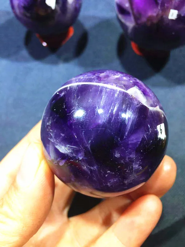 

Natural quartz crystal fantasy purple hand polishing ball. Home decoration. Decoration. Chakras