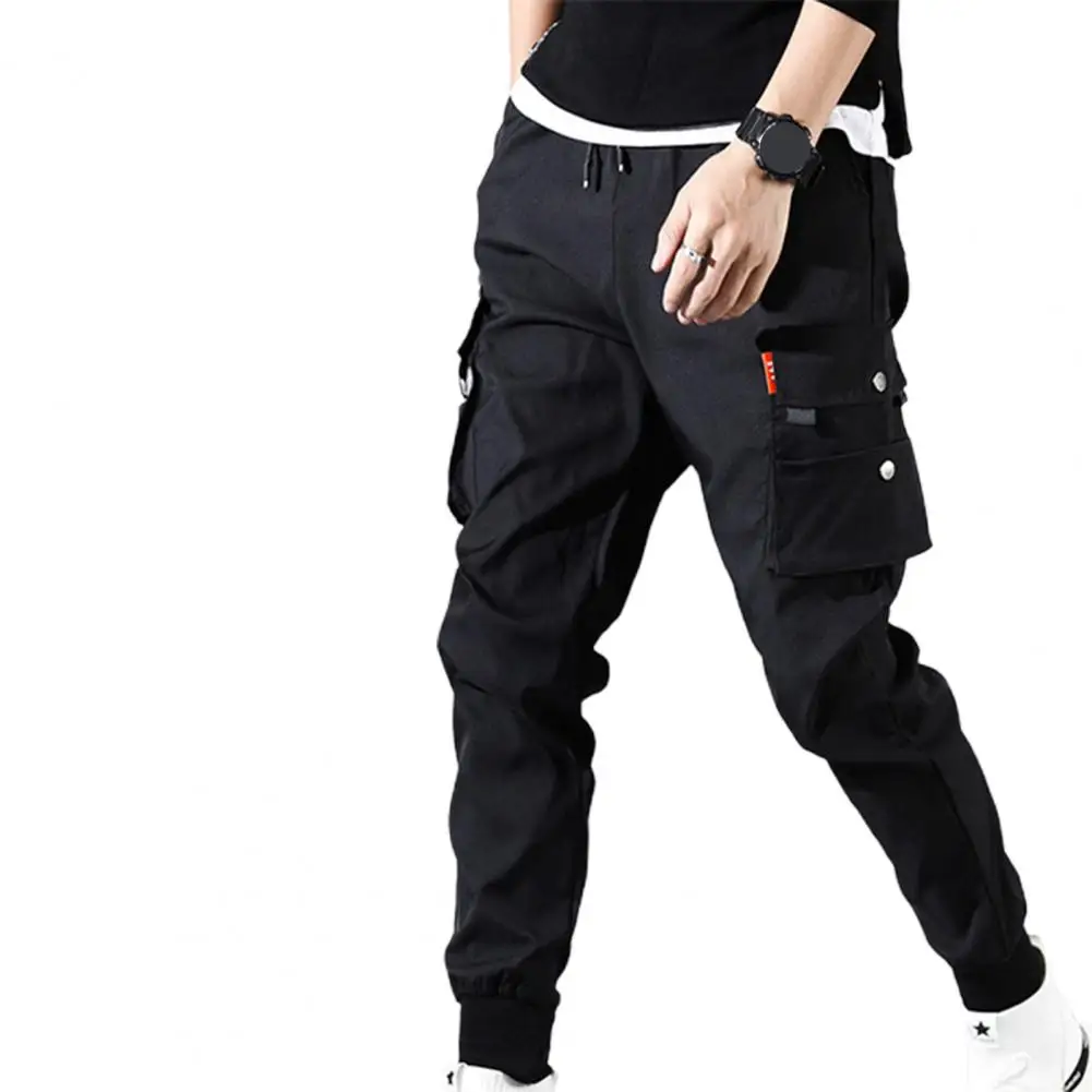 Pantalones de moda con múltiples bolsillos para hombre, pantalones de cintura elástica con cordón, pantalones de Jogger de Hip Hop, pantalones Cargo de pies de haz delgados de Color sólido