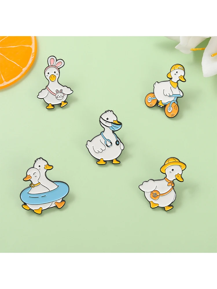 AliExpress XioMara Cute Funny Duck Enamel Pins Cool Duckling Ride Bicycle Metal Brooches Backpack Decorative Lapel