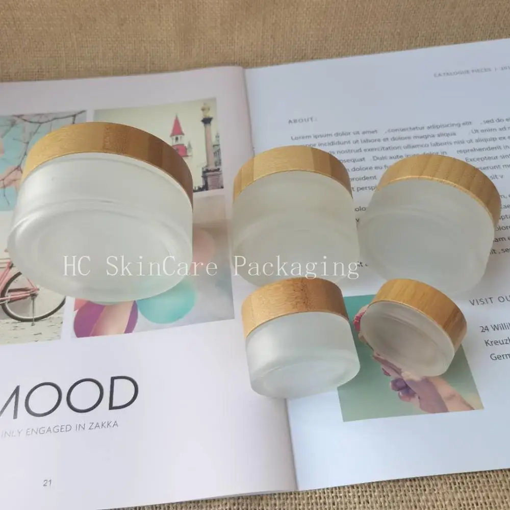 

Wholesale Recycled Frosted Clear Glass With Engraved Bamboo Lid,Skin Care Cream Jar Glass For Face Cream Lip Gloss Packaging