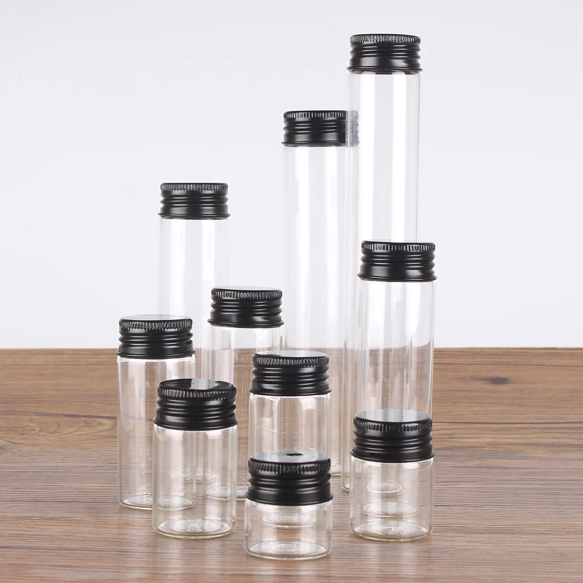 12 pieces/lot 10ml 15ml 20ml 25ml 30ml 40ml 50ml 60ml 80ml 100ml Glass Bottles With Black Aluminum Caps Potion Spice Jars Vails