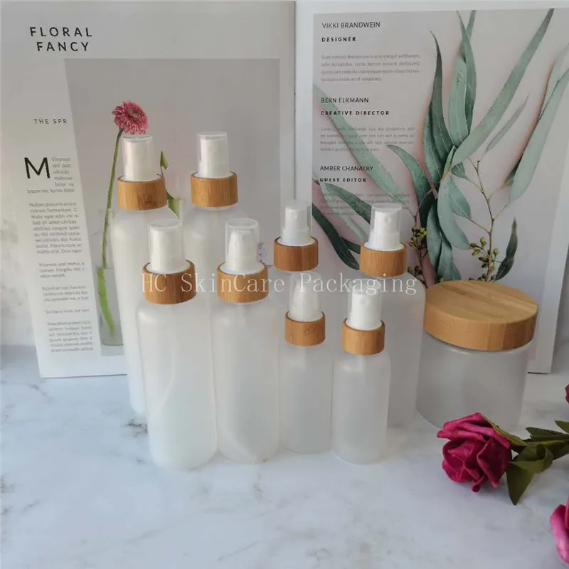 

bamboo cosmetic bottles Empty frosted /clear plastic bottle with bamboo lotion/spray cap and engraving logo bamboo cream jar