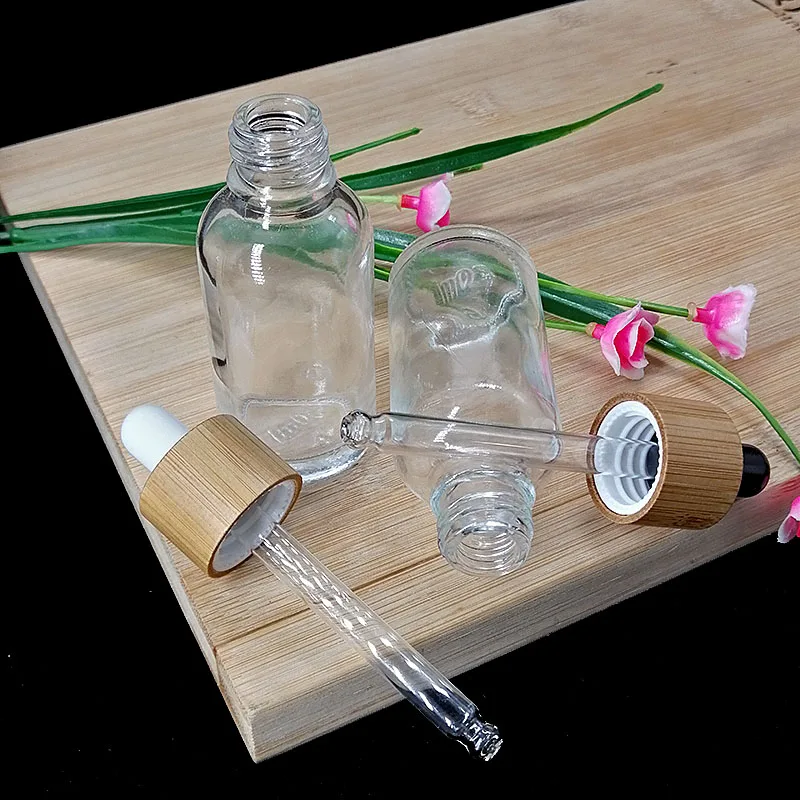 

Beauty Empty Clear Glass Essential Oil Bottles Bamboo Lid Dropper Packaging Cosmetic Toner Bottles Skin Care Packaging Makeup