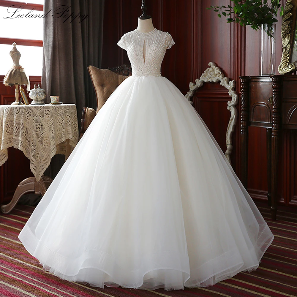 

Lceland Poppy Luxury A-line O-neck Wedding Dresses Pearls Beaded Tulle Floor Length Cap Sleeves Bridal Gowns Sweep Train