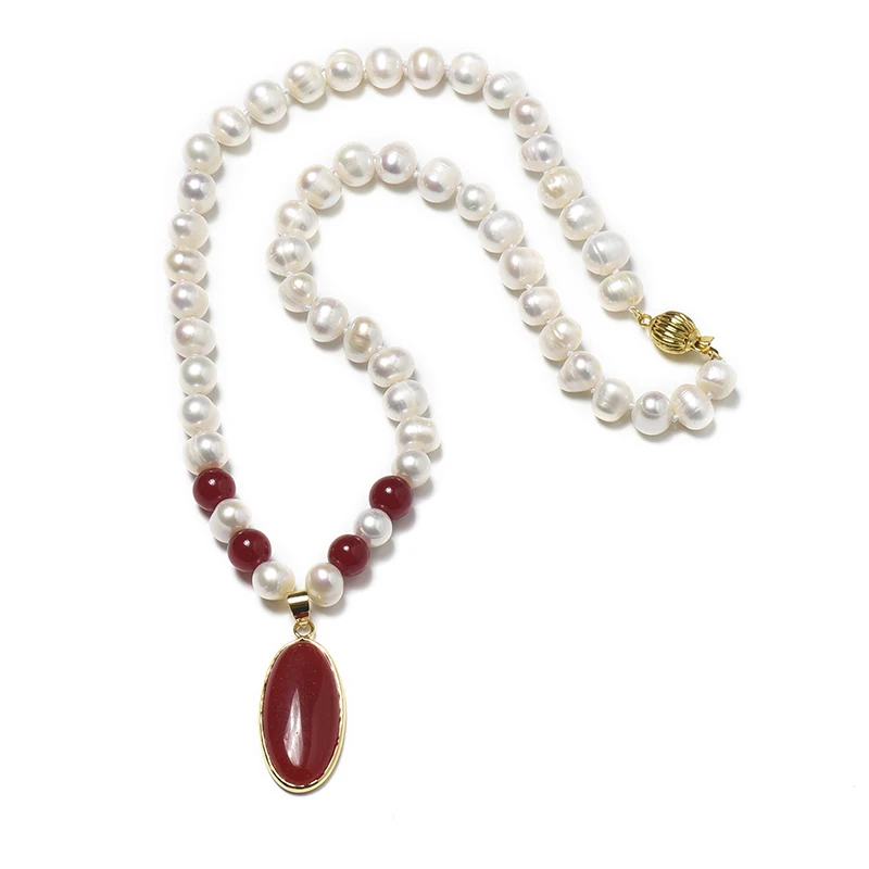 A slender crimson Oval 16*32*6 mm  Pendant is attached to a 8-9 MM natural pearl necklace with red balls and white pearls.