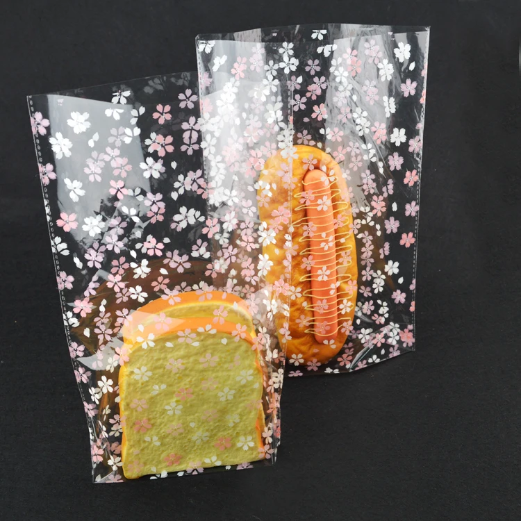 

Free shipping 300pcs Sakura Flower Translucence Cellophane Bags Handmade Plastic Package for Party Bread & Cake Wrappers