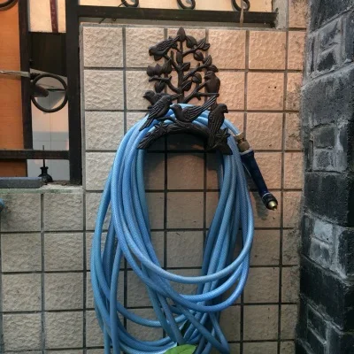 

Wall Mounted Cast Iron Garden Hose Hanger Rack with Bird Ornament and Tree Branch Design