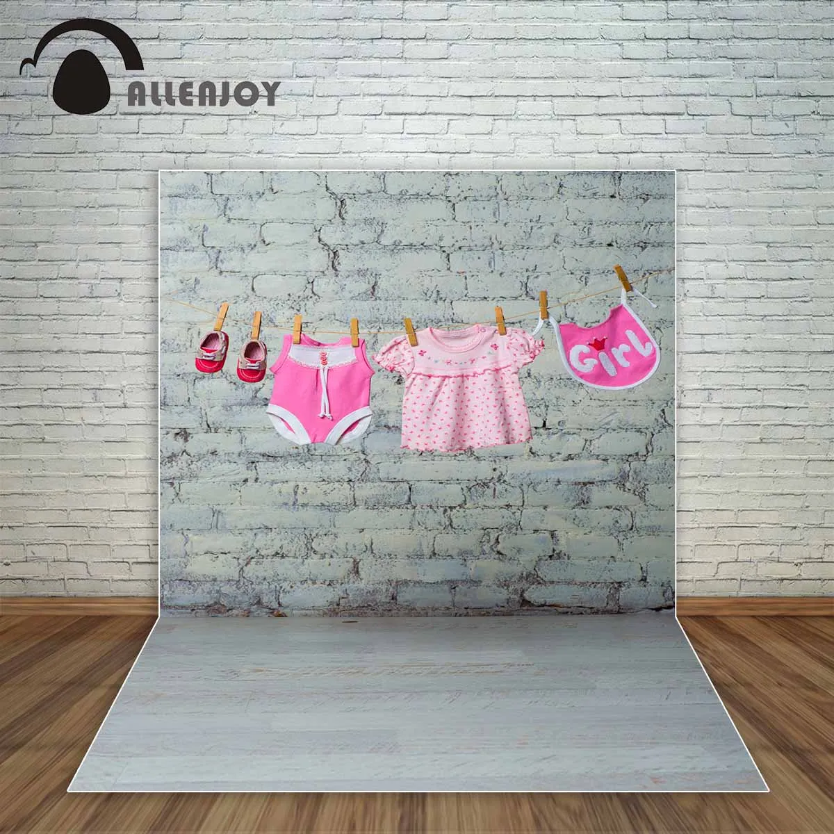 Allenjoy baby girl's pink onesie bib dress and red shoes dry on a rope against a white brick wall photography backdrops a photo