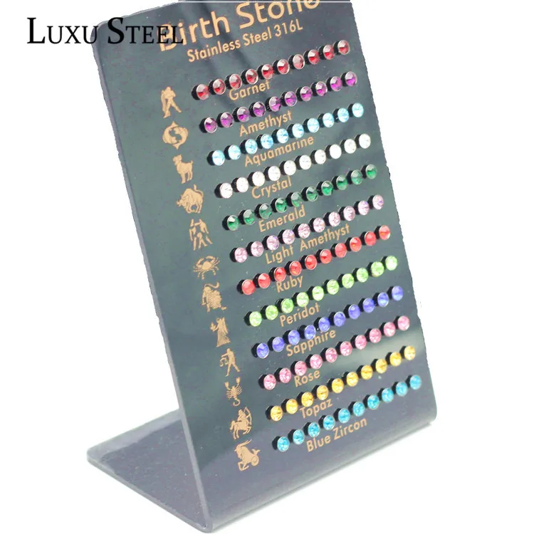 LUXUSTEEL-Juego de pendientes de circonia cúbica, aretes de acero inoxidable, 12 Constelaciones, piedra de nacimiento, 60 pares por tarjeta