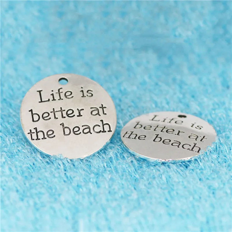 Top Quality 10 Pcs/lot Diameter 23mm Life is better at the beach Antique Silver plated Round Disc Quote Message Charms Pendant