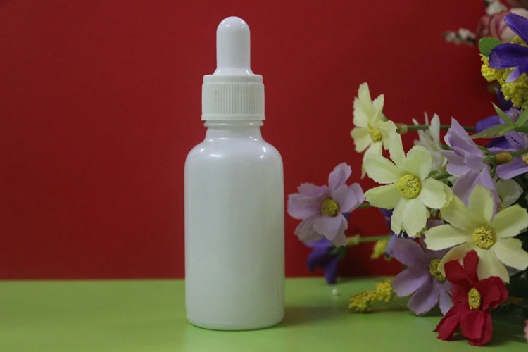 

wholesale 100pcs white color glass 1 ounce dropper bottles with white cap , 1 oz dropper bottle glass with plastic gold cap