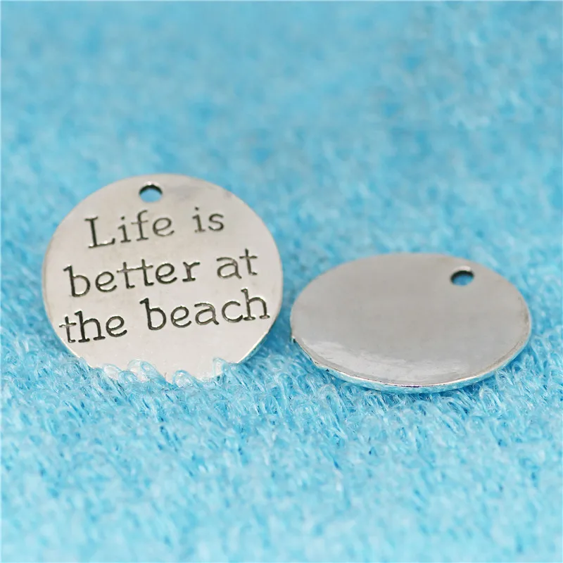 Top Quality 10 Pcs/lot Diameter 23mm Life is better at the beach Antique Silver plated Round Disc Quote Message Charms Pendant