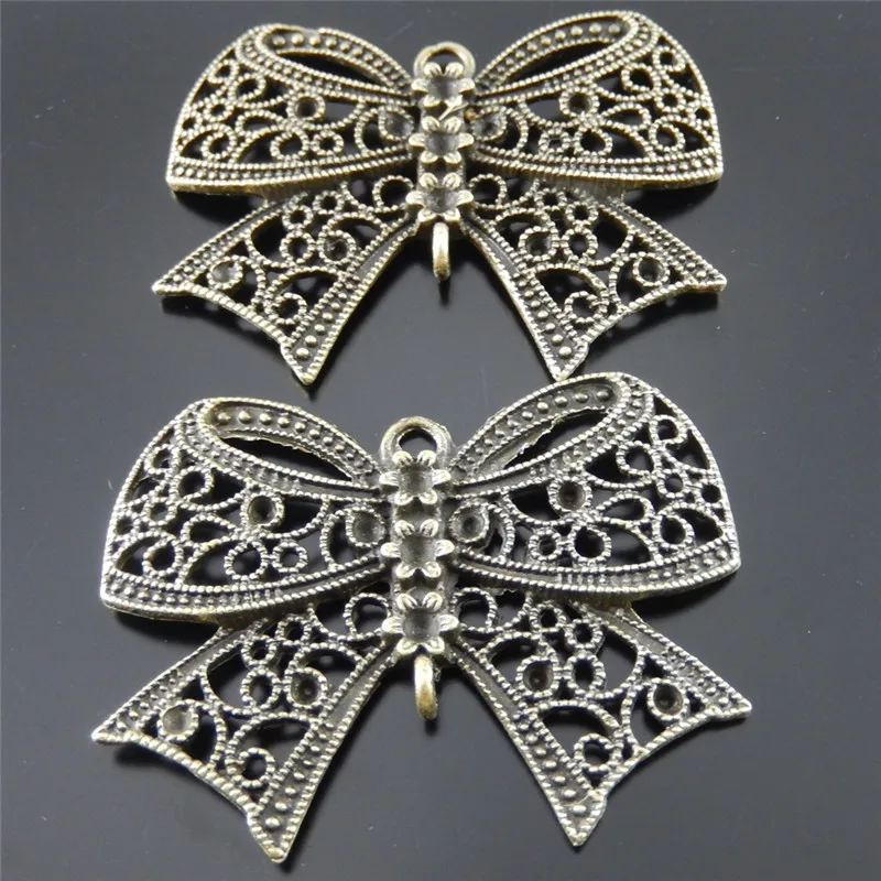 Julie Wang 2PCS Bowknot Charms Alloy Antique Bronze Hollow Bow Skeleton Pendant Necklace Jewelry Making Handmade Hanging Tops