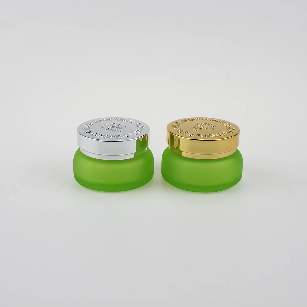 

Empty 30g frosted green glass cream jar with silver and gold lid, 1 oz glass cosmetic packaging