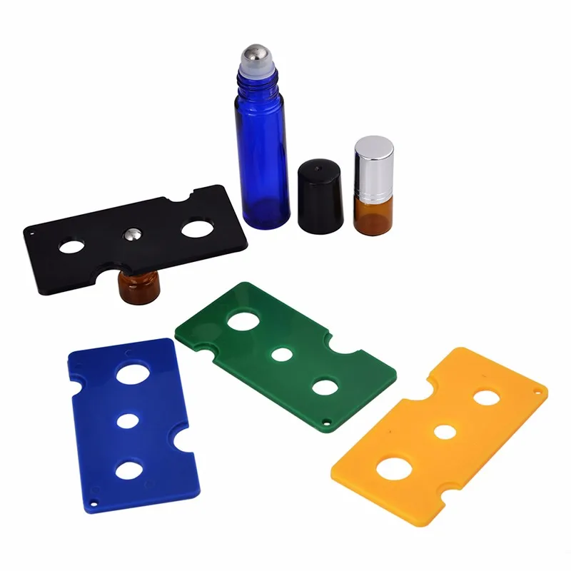 100 X envío gratis abridor de aceite esencial colorido herramienta clave removedor para bolas de rodillo y tapas botellas verde negro azul amarillo