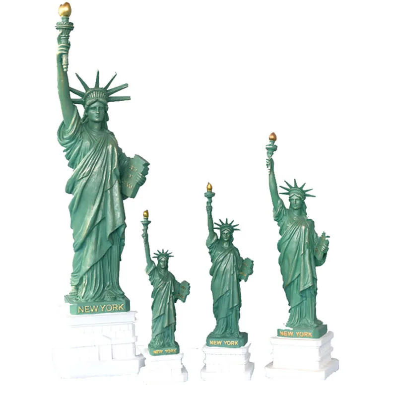 A Statue of liberty sculpture is displayed on living room office book desk as tourist souvenir in New York crafts bookshelf home