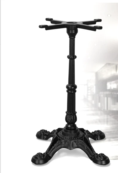 Western restaurant. The table legs. The legs. Support.. Wrought iron table leg.