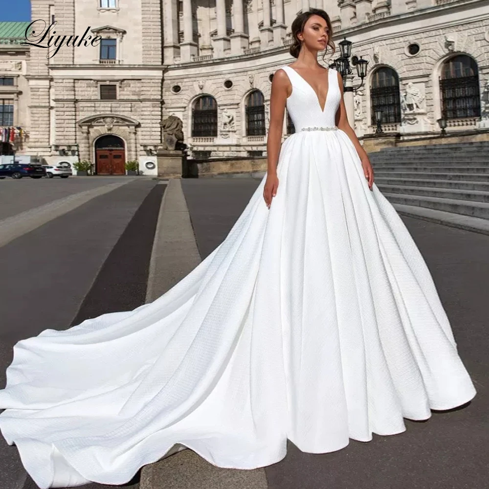 

Liyuke Ivory Color Grid Lace A-Line Wedding Dress With Deep V-Neckline Sleeveless Chapel Train Wedding Gown