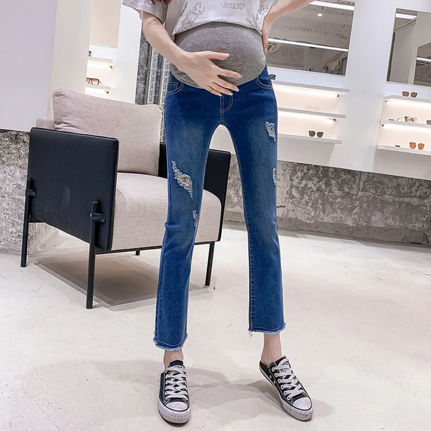 Spring andautumn new pregnant women stomach lift jeans Korean version of the wild fashion tide hole micro horn nine points pants