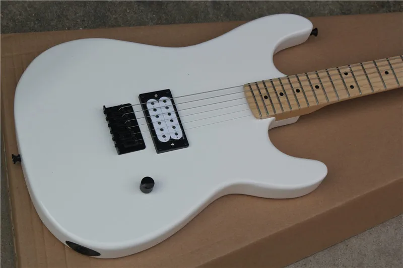 White electric guitar,H pickups,fixed bridge, strings through body,black buttons,white guitar