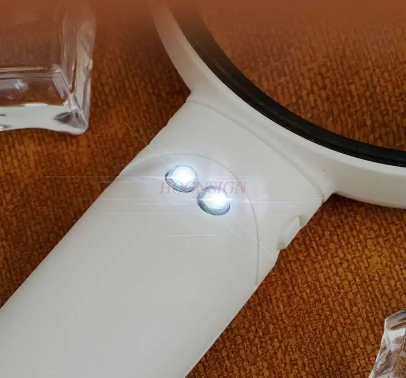 Students use handheld magnifying glasses with LED lights and optical transparent magnifying devices,