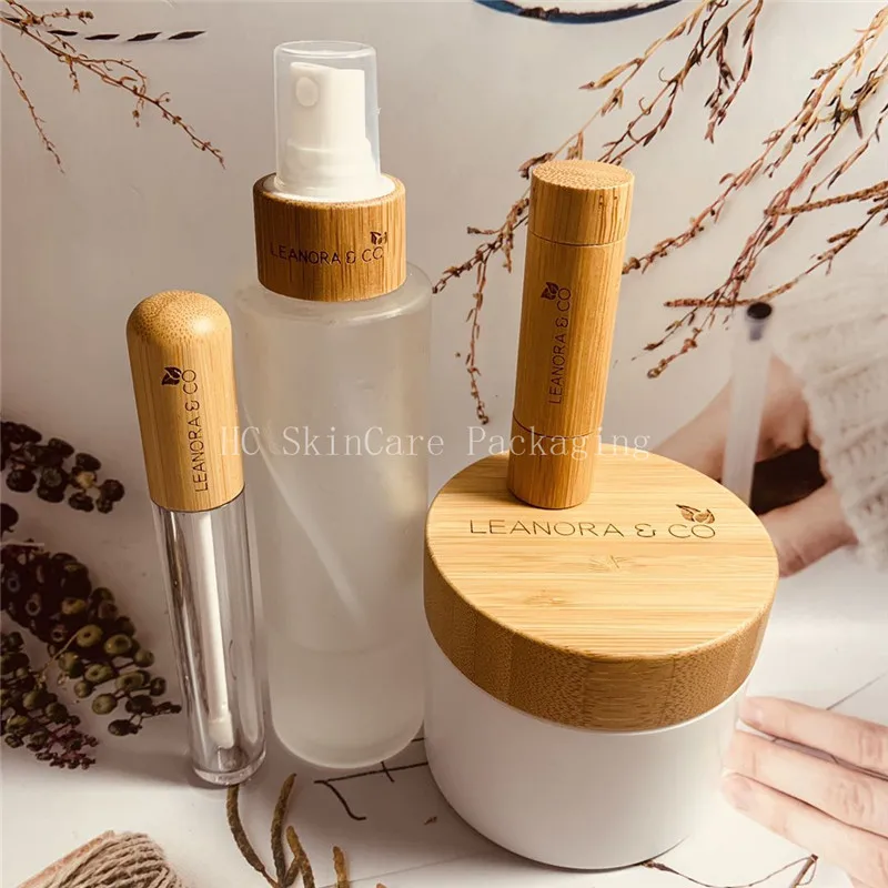 

Hot sale spray bottles 100ml transparent frosted glass bottle Environmental bamboo lid lip gloss tube empty cosmetic containers