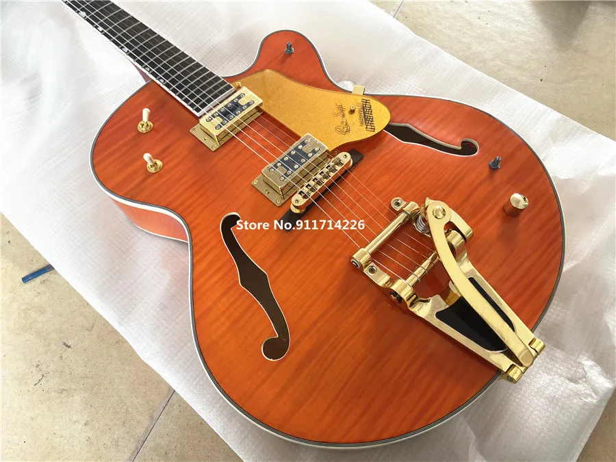 High quality custom version of jazz double F hole orange electric guitar gold large rocker vibrato