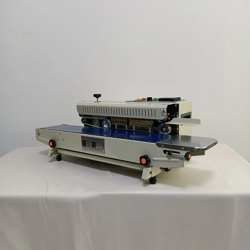 حار بيع آلة الختم المستمر للأكياس البلاستيكية مع آلة ختم الأكياس فيلم الحزام الناقل