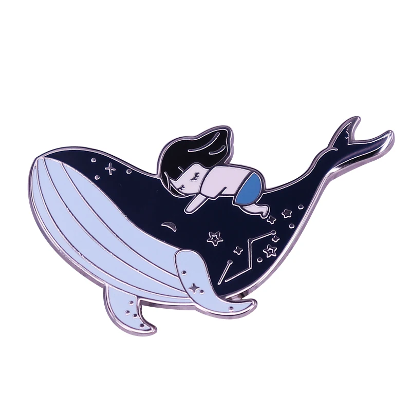 This beautiful badge tells a story of whale and girl, both lovers of the sea and coexisting in this galaxy.