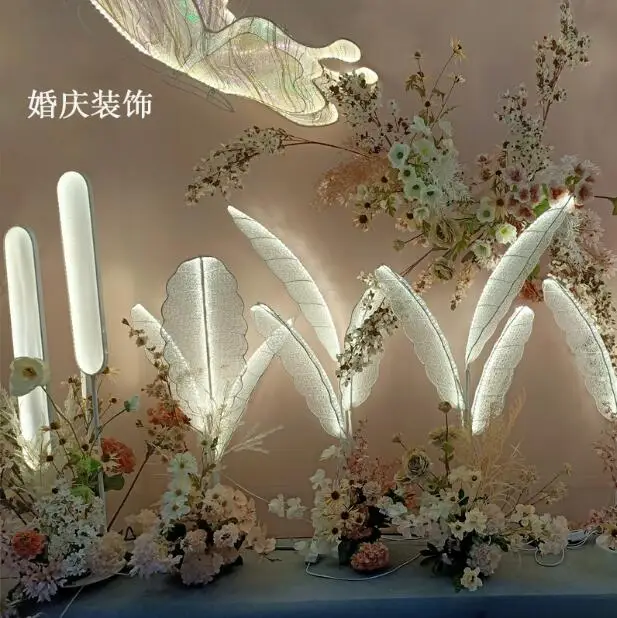 New wedding background decoration props feather lamp shines banana leaf butterfly crossing the road to lead the wedding window s