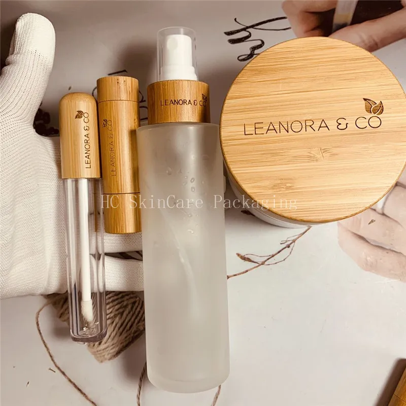 

Custom Logo spray bottles 100ml transparent frosted glass bottle bamboo lid lip gloss tube empty cosmetic containers