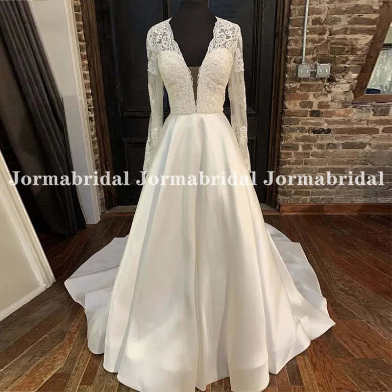 

Charming A-Line Wedding Dresses Deep V-Neck Lace Appliqued Sheer Long Sleeves Bridal Dress Transparent Buttons Back Trouwjurk